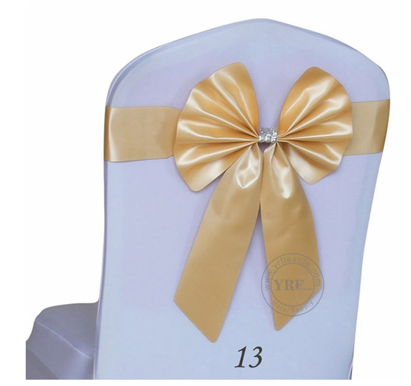 white chair covers with gold sash