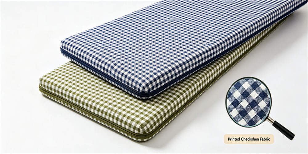 Printed check mattress cover and complete folding pads showing the visible fabric pattern and finished edges.
