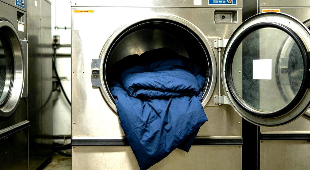 Industrial washer navy clean showing navy and grey institutional bedding for remote worker accommodation and industrial camp facilities