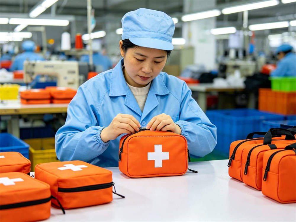 Quality inspection scene of Asian worker in light blue uniform inspecting stitching on orange first aid kit with white cross bright factory quality control area