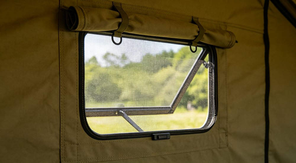 Professional emergency relief tent photographed in field deployment showing sturdy construction waterproof fabric and steel frame design suitable for disaster response and humanitarian aid operations