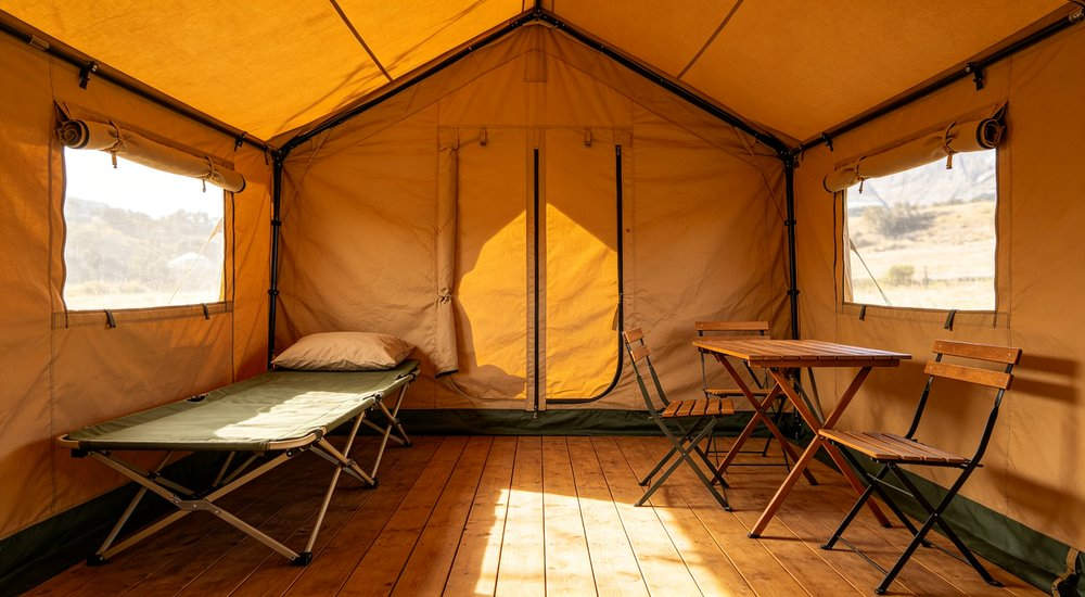 Heavy duty emergency frame tent displayed in operational setting demonstrating quick setup capability durable canvas exterior and spacious interior capacity for humanitarian relief missions