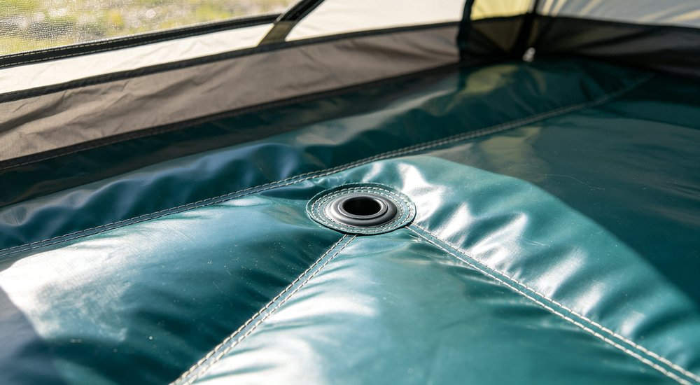 Reinforced PVC floor of inflatable tent showing thick durable material, close-up detail, bright lighting, reinforced PVC floor for clean and dry interior space