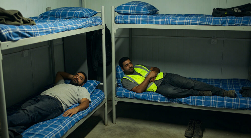 Eye-level shot of university dormitory room with students using institutional bedding in student housing accommodation suitable for emergency shelters hospitals universities and hotels requiring durable comfortable bedding solutions