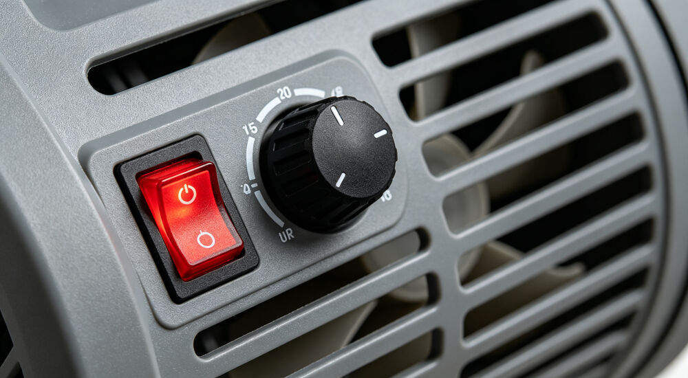 Adjustable speed control knob and red power switch closeup of electric air blower for inflatable tent Adjustable speed control knob and red power switch closeup of electric air blower for inflatable tent