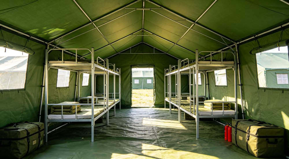 Closeup exterior detail showing reinforced corner seams heavy duty waterproof fabric texture and weatherproof construction of professional emergency relief shelter