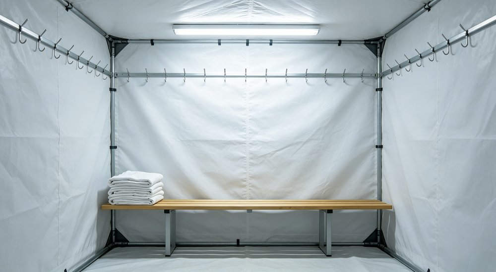 Changing area inside inflatable decontamination tent with benches and hooks, bright interior red and white inflatable emergency shelter for disaster relief operations