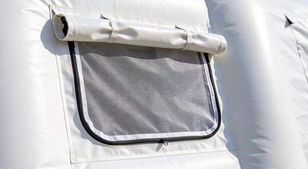 Ventilation window on inflatable isolation tent, close-up of adjustable vent, bright lighting red and white inflatable emergency shelter for disaster relief operations