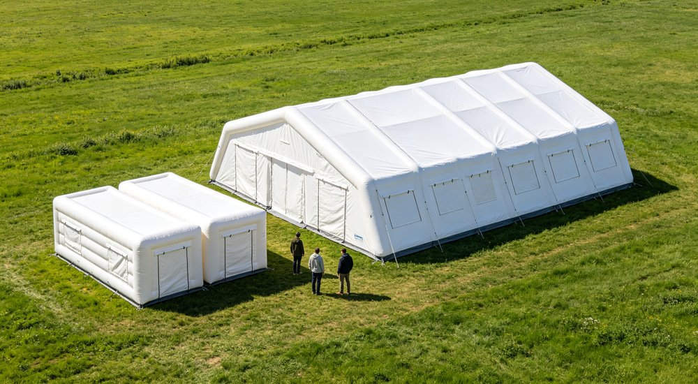 3 module vs 6 module inflatable tent system comparison showing size difference, green grass, blue sky red and white inflatable emergency shelter for disaster relief operations