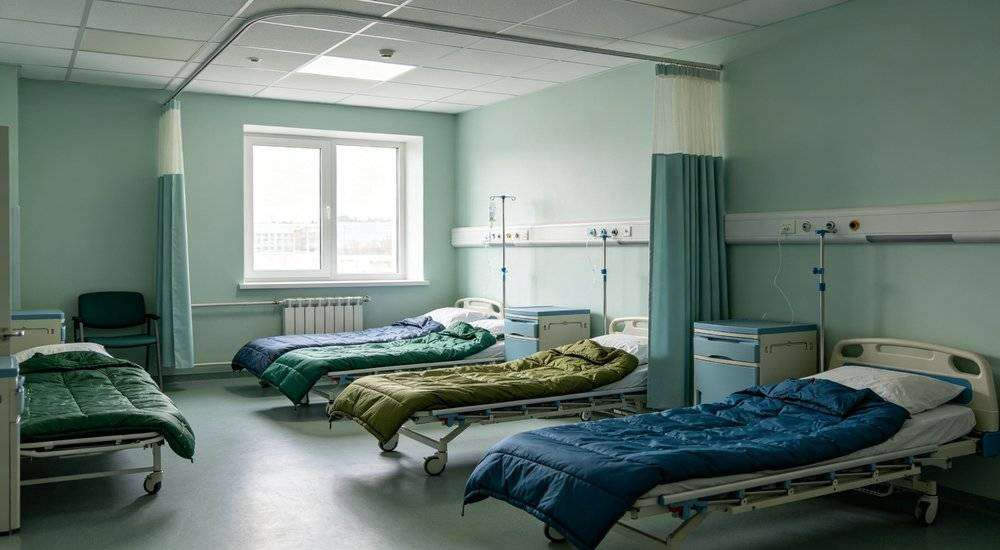 Wide angle view of hospital ward with sleeping bags arranged for patient rest medical facility accommodation