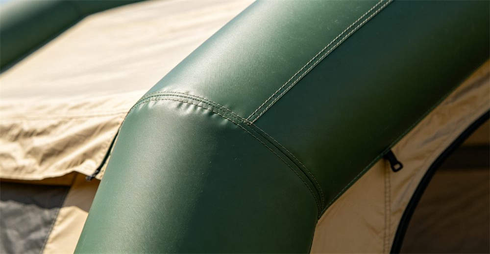 Close up detail of durable 1000D PVC air beam construction of an inflatable tent showing high frequency welding seams and heavy duty material texture with professional product photography quality standards