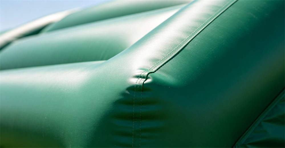 Close up detail of smooth high frequency welded PVC air beam of an inflatable tent showing perfectly welded joint with no stitching visible and heavy duty material texture in professional macro shot photography