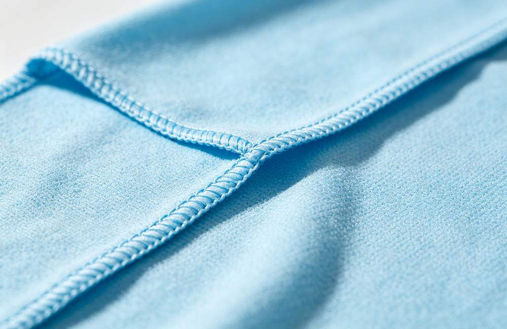 Close up of cooling towel reinforced edge stitching detail showing durable lock stitch construction