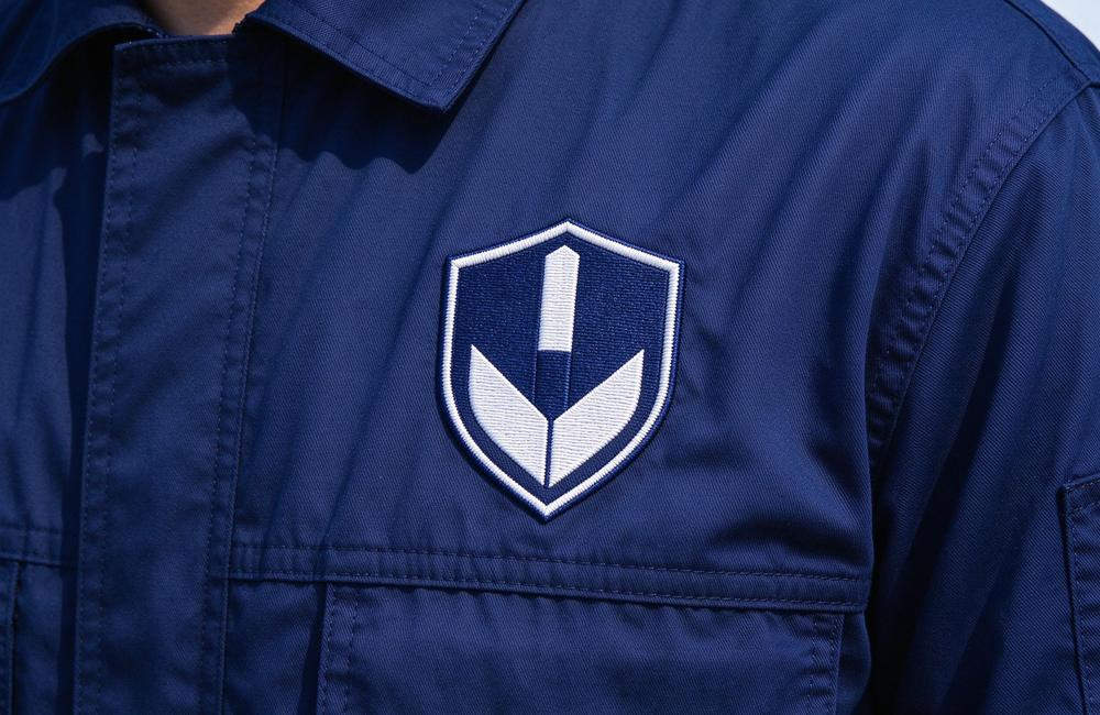 Close-up view of fR coveralls breathable fabric detail for flame resistant workwear comfort in hot conditions and fire resistant clothing wearing experience for flame resistant workwear buyers Close-up view of fR coveralls breathable fabric detail for flame resistant workwear comfort in hot conditions and fire resistant clothing wearing experience for flame resistant workwear buyers