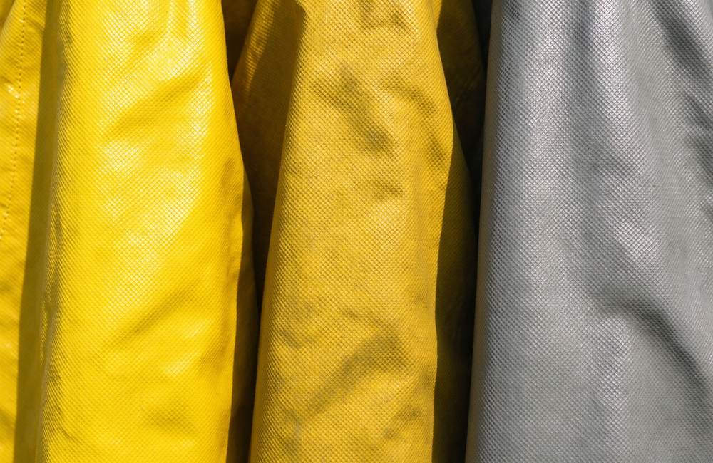 Three-quarter view of yellow ventilated fire resistant chemical suit back view with ventilation design for firefighter hazmat suit comfort and chemical protective clothing long duration wear