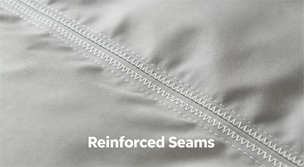 Close-up view of reinforced seam detail on refugee camp bedding, double stitched edges on durable emergency shelter linen built for rough relief camp handling and reuse, professional textile photography with bright even lighting for humanitarian relief procurement buyers