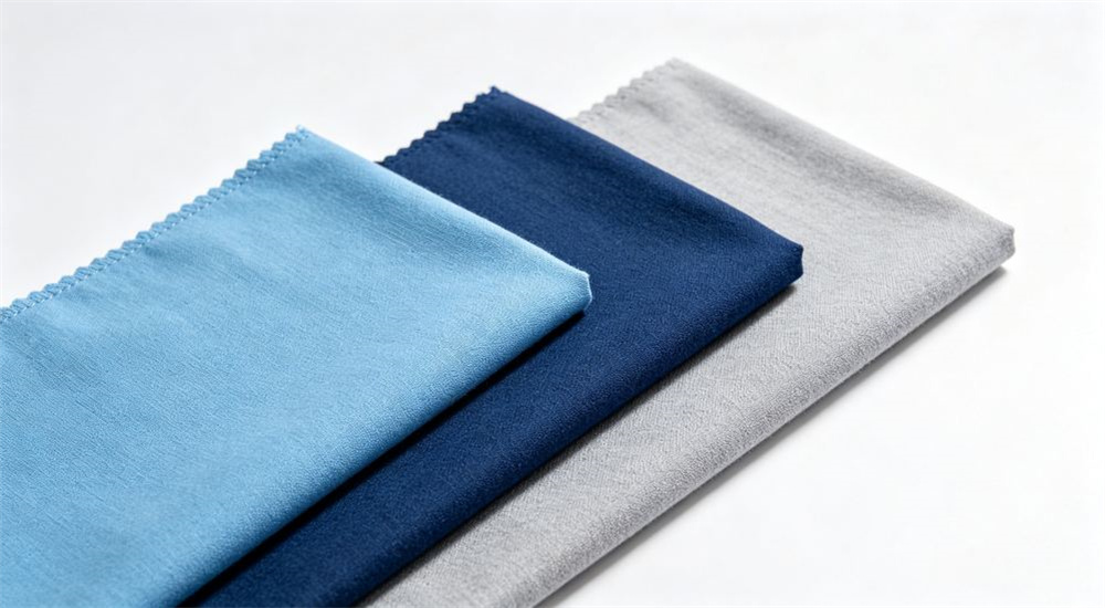 Close up detail of stitched hems and reinforced seam finishing on blue and white gingham dormitory fabric, showing quality construction for wholesale school dormitory bedding that withstands daily student use and washing