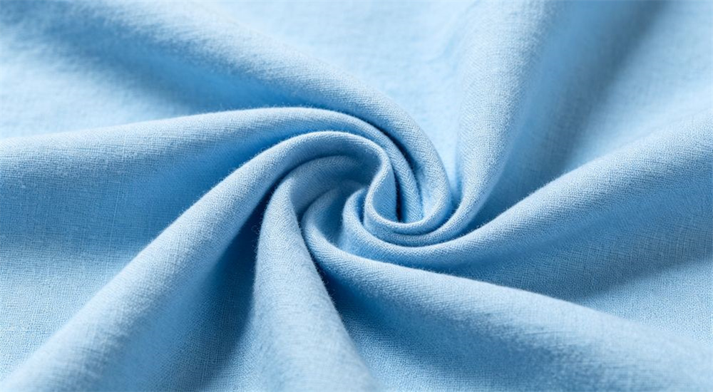 Macro close up of white 100 percent cotton dormitory fabric weave showing soft breathable texture and fine yarn detail, premium student housing bedding material for wholesale school dormitory orders, and soft breathable hand feel suited to premium university residence rooms.