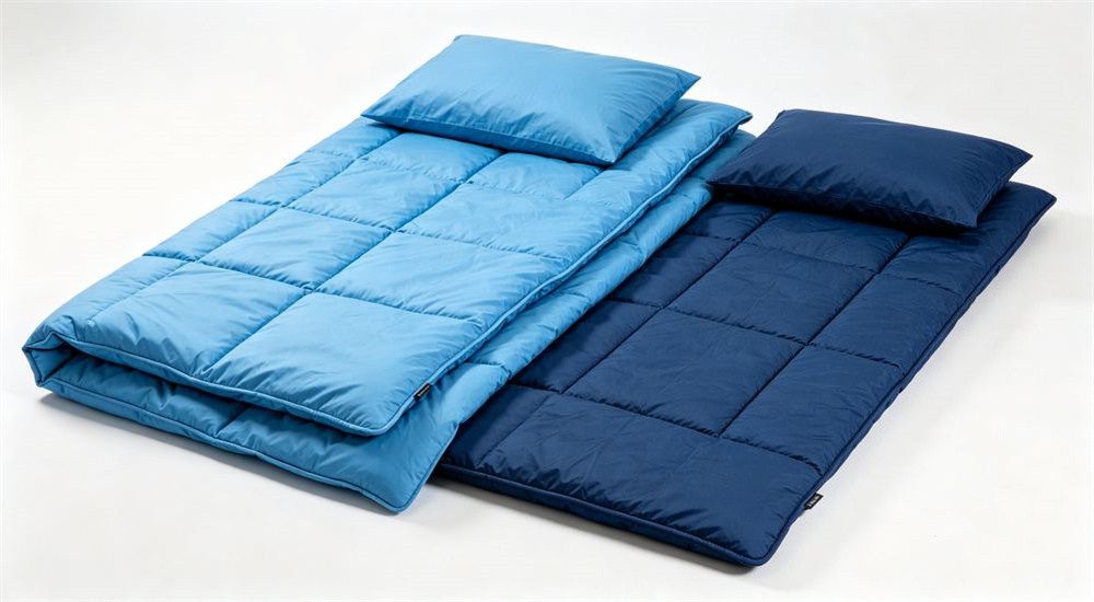 45-degree angle of clean white background product family of sky blue navy and white emergency relief bedding sets neatly folded, wholesale humanitarian disaster shelter linen final showcase, and wholesale humanitarian disaster shelter linen for relief agency supply.