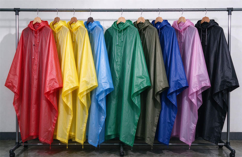 Rain ponchos in different colors hanging on a rack, product photography, rain poncho bulk for evacuation in bad weather. Rain ponchos in different colors hanging on a rack, product photography, rain poncho bulk for evacuation in bad weather.