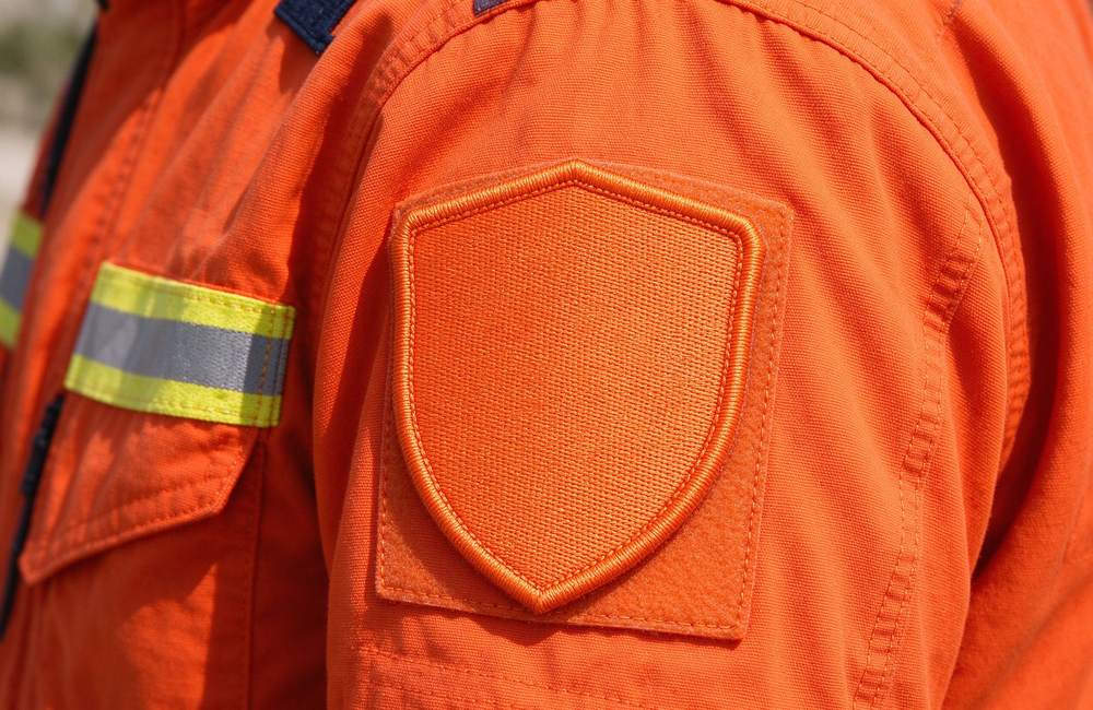 Three-quarter view of emergency rescue clothing storage and inventory in warehouse for orange with reflective trim rescue uniform bulk stock and emergency response clothing logistics planning for emergency rescue clothing buyers