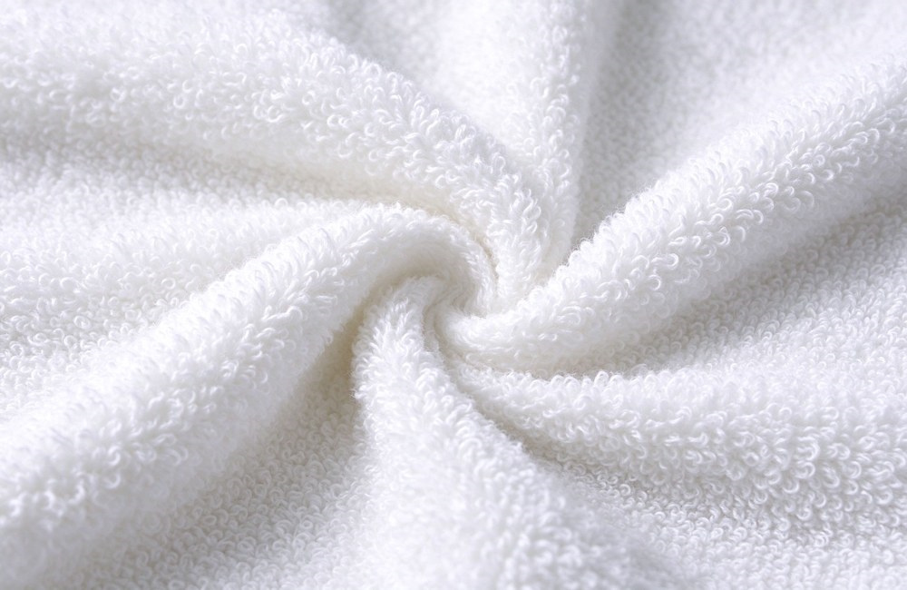 Extreme macro closeup of ultra fluffy zero twist white cotton towel loops soft cloud like terry texture premium spa towel weave absorbent plush soft finish hotel spa towels wholesale factory direct China supply bulk order sample