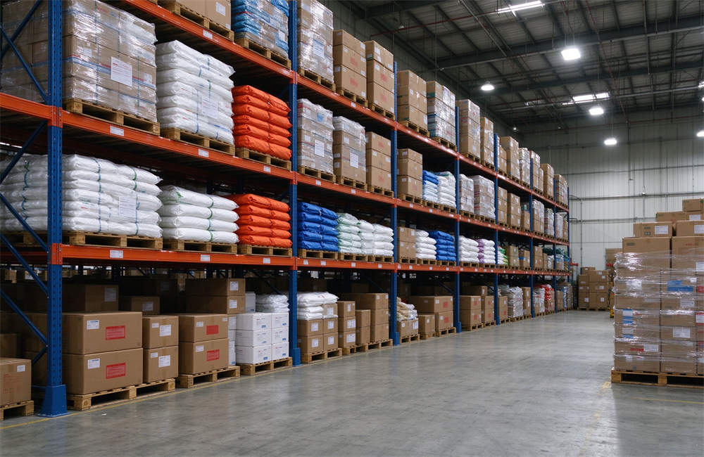 Large clean warehouse interior with tall shelves stacked with emergency relief supplies, organized inventory of disaster response equipment and wholesale emergency supplies