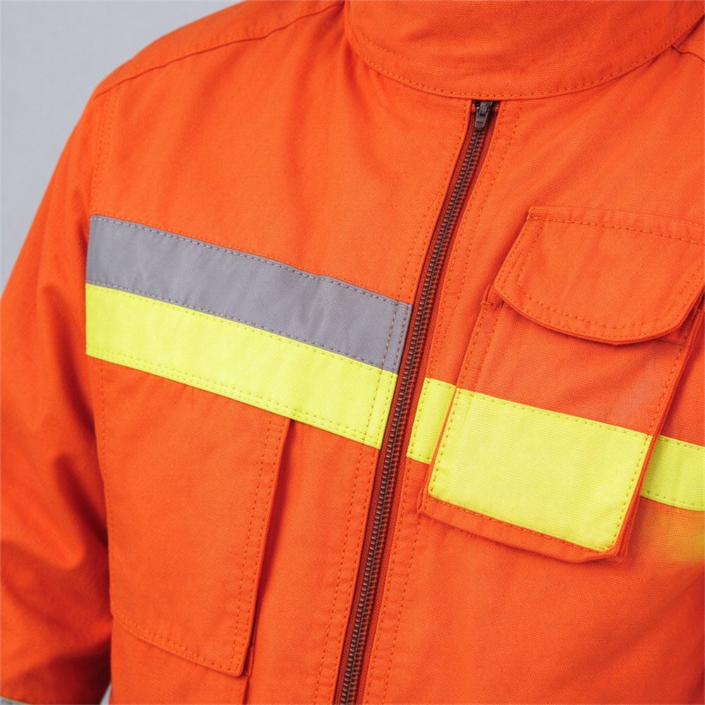 Detail shot of 3M Scotchlite reflective trim radio pocket with flap and heavy-duty zipper closure on orange firefighter turnout coat showing hardware quality