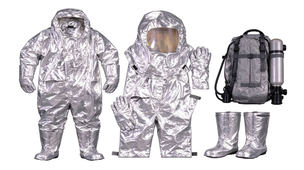45 degree angle of heavy duty protective thermal chemical composite suit, Chemical plant team lined up in fire chemical suits, chemical protective clothing, demonstrating professional product use in industrial safety environment, designed for wholesale bulk supply and industrial safety procurement.