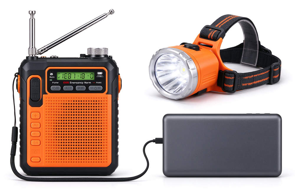 Hand crank emergency radio, LED headlamp, portable power bank flat lay, off-grid emergency communication and lighting gear for carbon monoxide safety and power outage preparedness