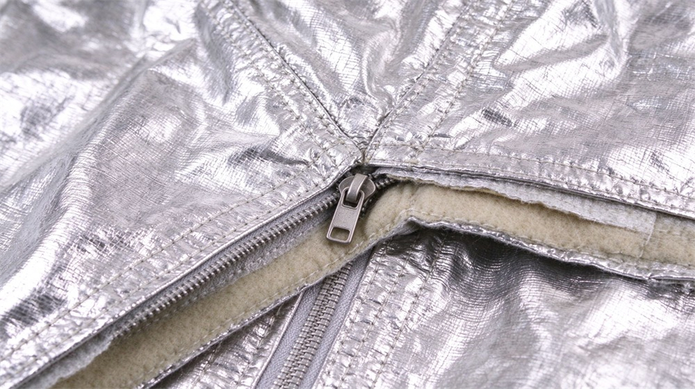 Wide shot of heavy duty protective flame resistant cbrn suit, Close-up of sealed seams on fire resistant chemical suit, dual barrier construction, demonstrating professional info use in industrial safety environment, designed for wholesale bulk supply and industrial safety procurement.
