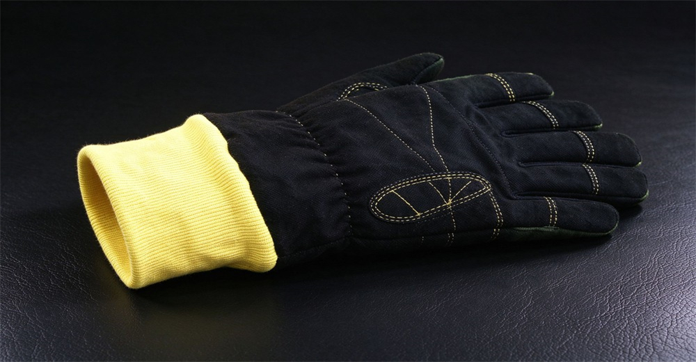 Black fire protective glove with bright yellow knitted cuff and reinforced stitched palm sections